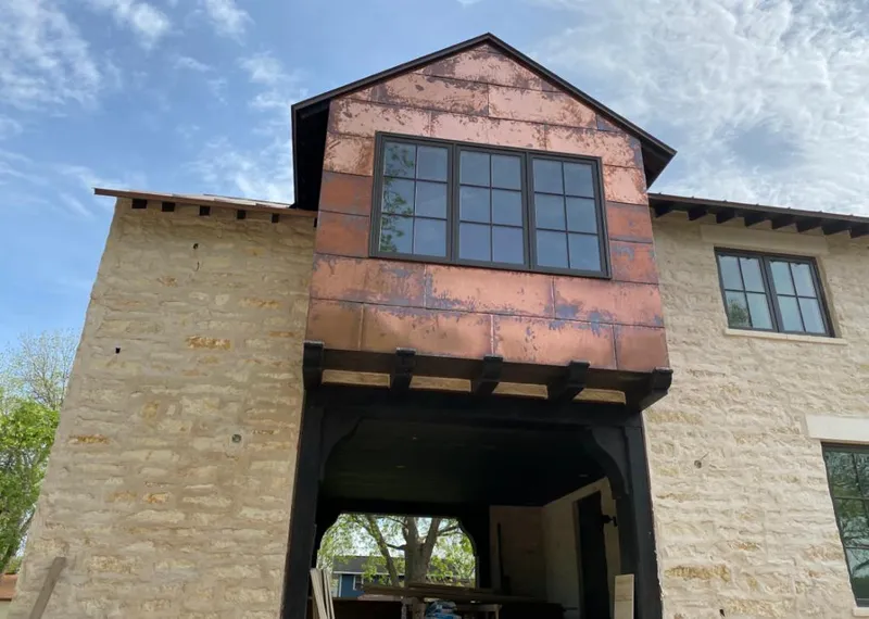 Copper metal panel facade on a stone building for Skylight Installation in Pukalani